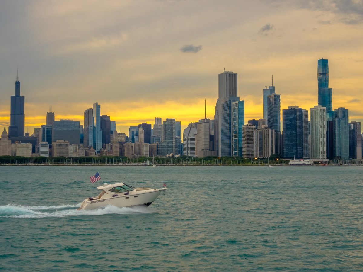 Speedboat cruising across a lake at golden sunset